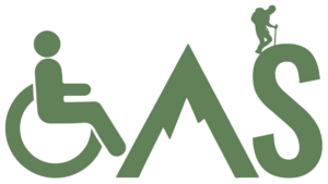 A logo featuring a green wheelchair symbol on the left, merging into a stylized green mountain peak in the center, and the letter "S" on the right. A small silhouette of a hiker with a backpack and walking stick stands on the peak of the "S"
